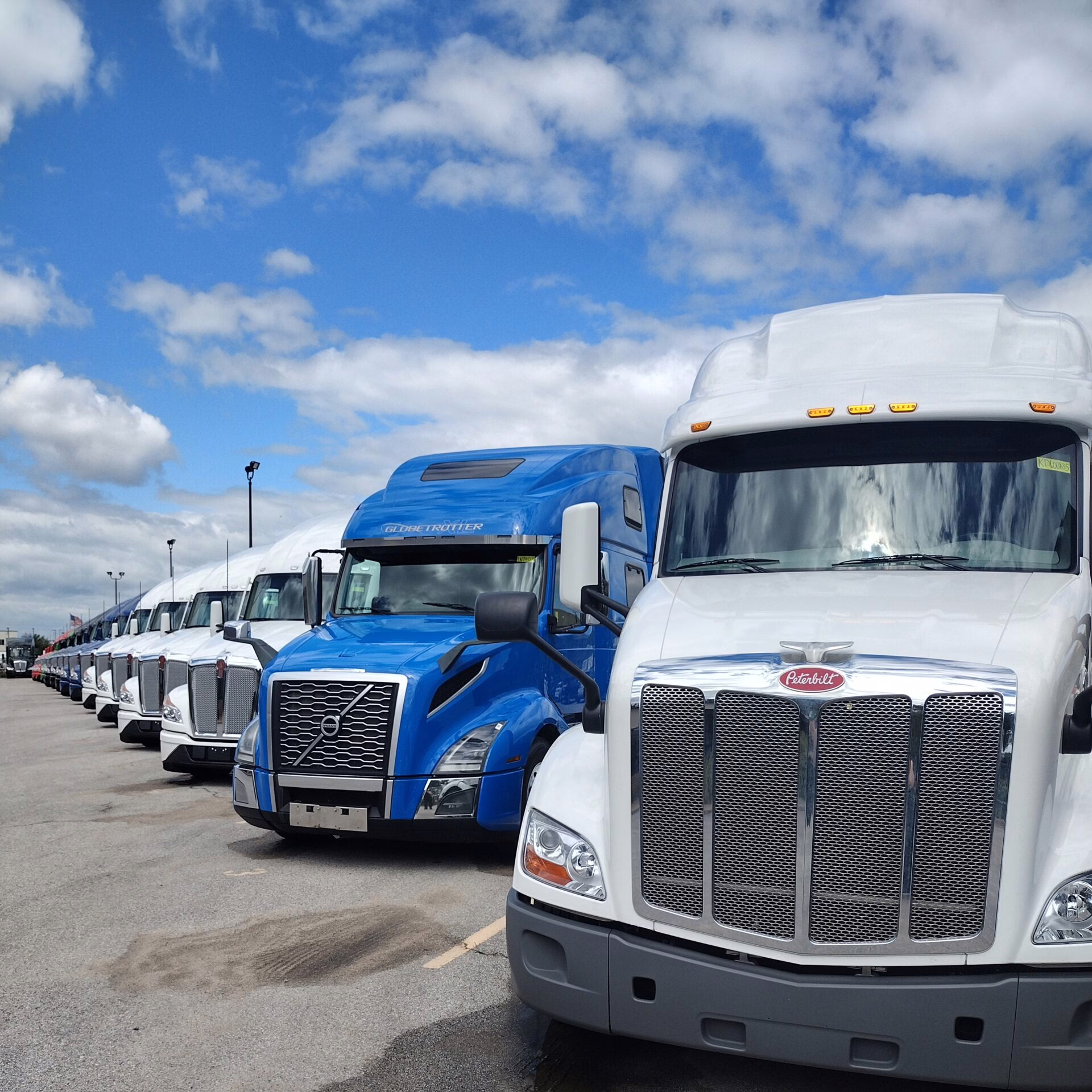IMG_20230814_150708598_HDR row of white and blue semi trucks