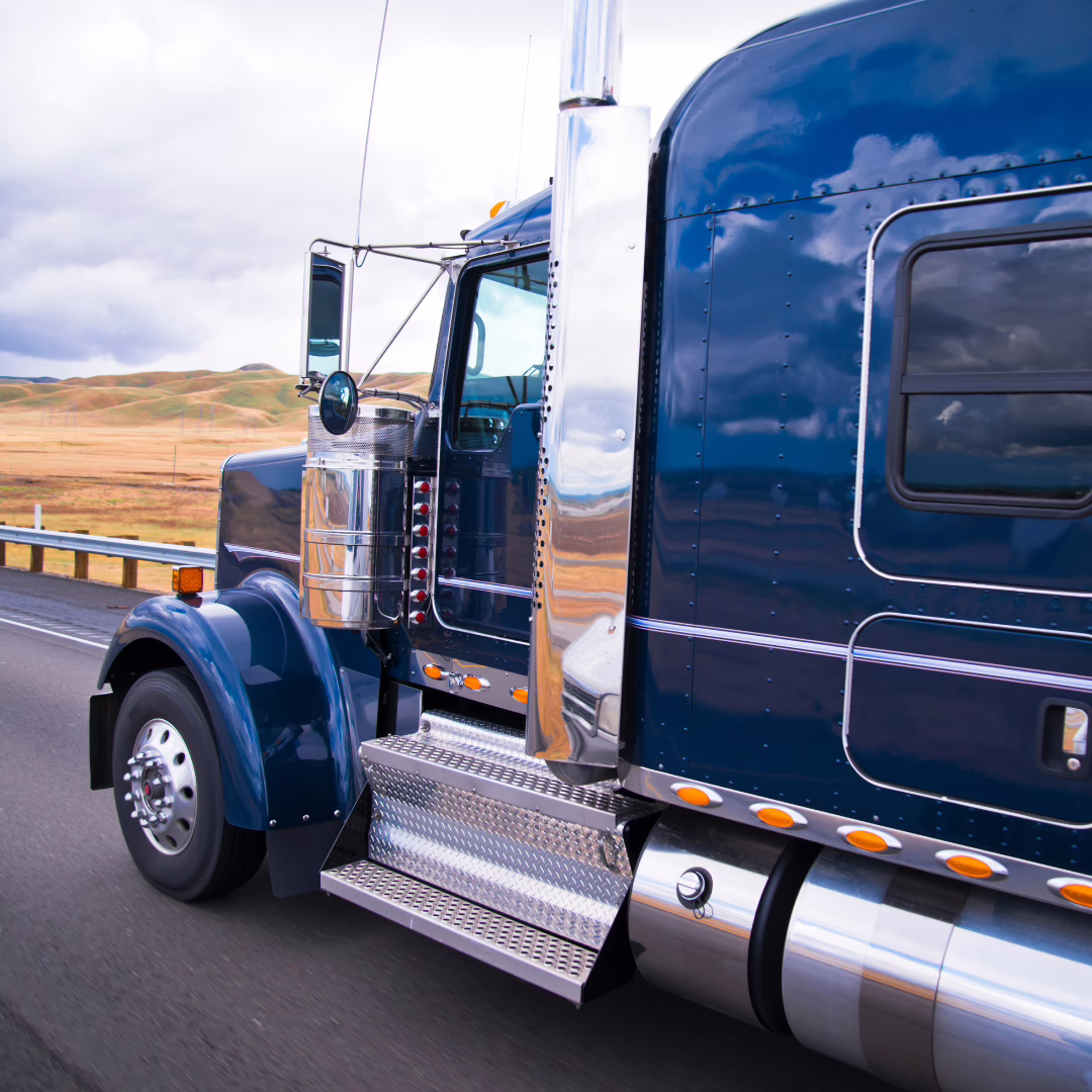 Blue semi truck driving on highway
