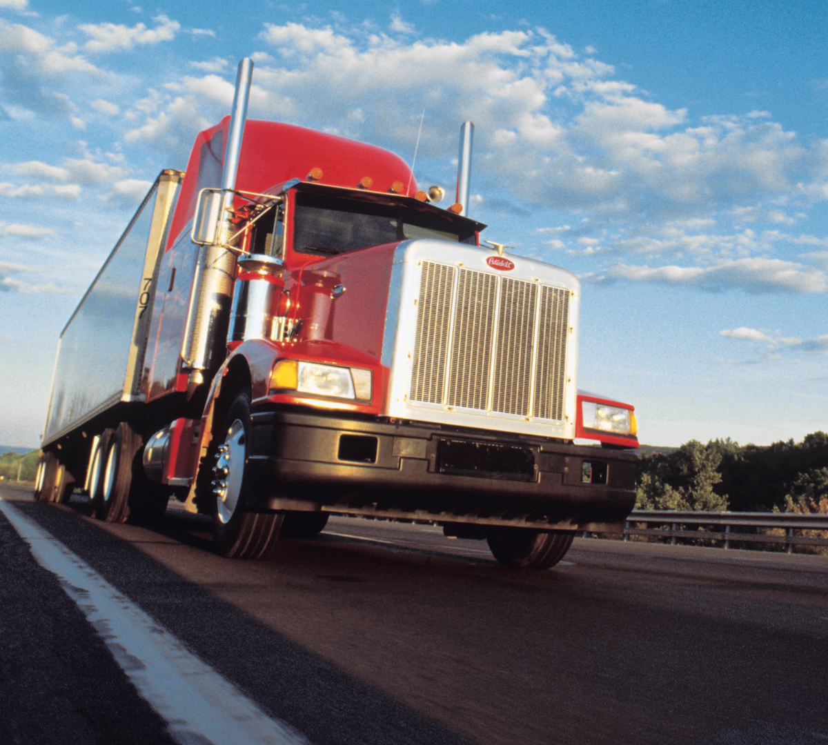 Semi-truck and trailer driving down a highway